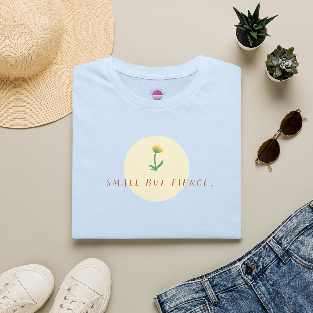 Small But Fierce Women's Minimalist T-Shirt laid flat with floral design on light blue fabric.