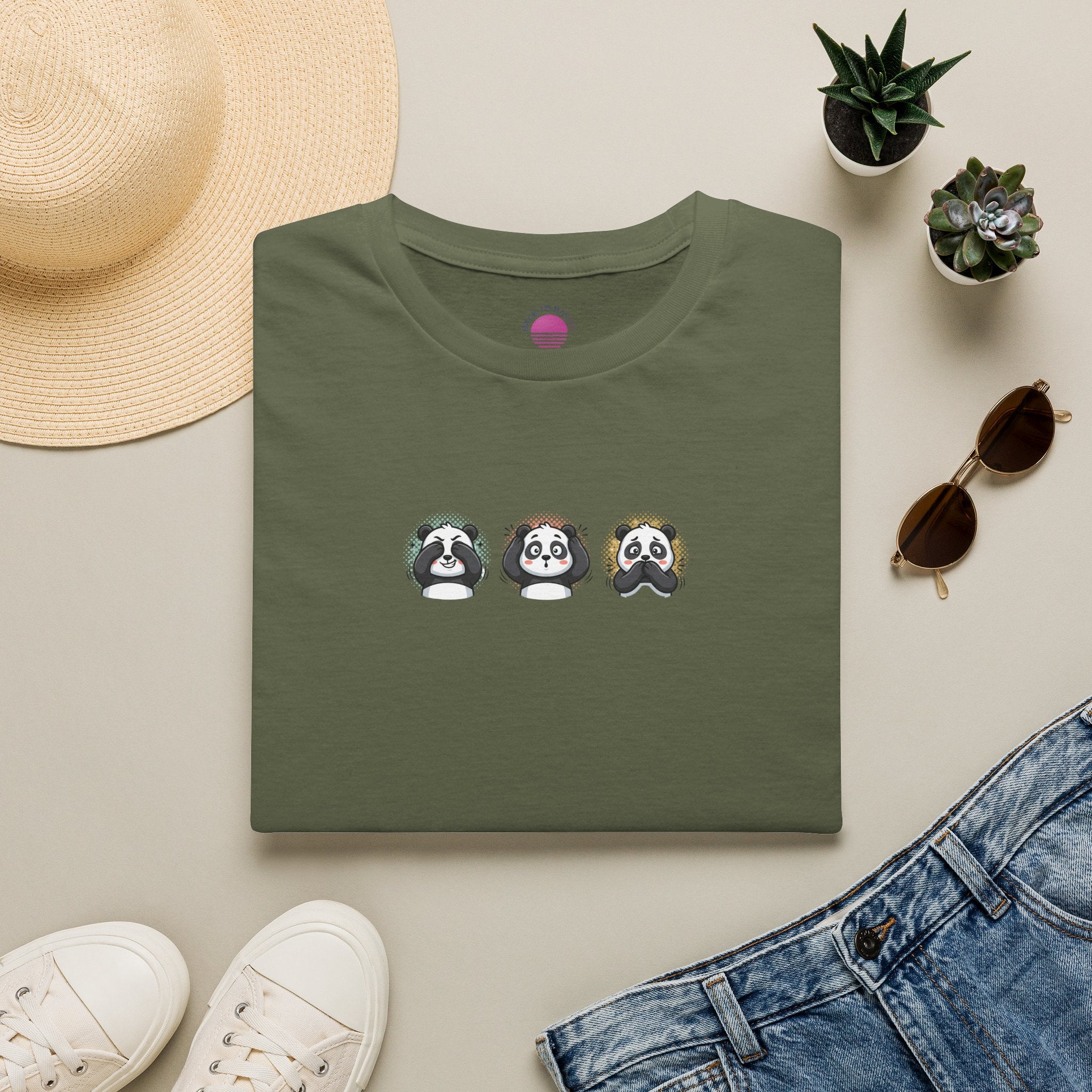 Panda Trio graphic t-shirt featuring cute cartoon panda faces on a green tee.