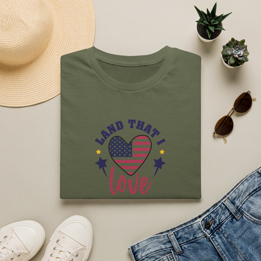 Patriotic t-shirt with American flag displayed on a flat lay of shirt, sunglasses, shoes, and accessories.