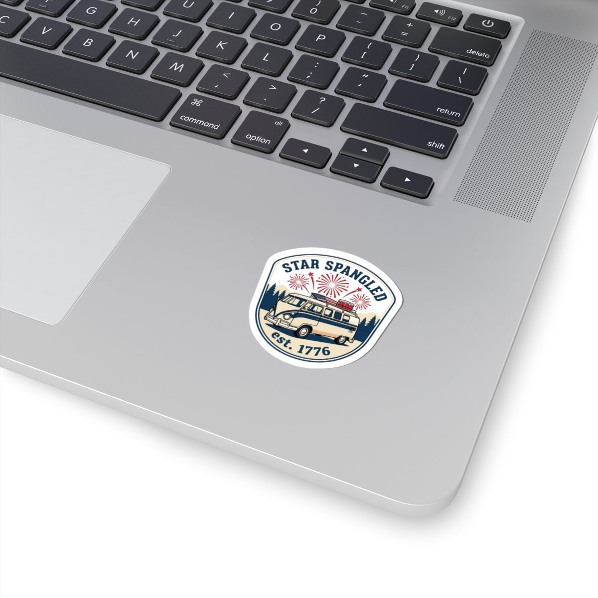 custom kiss-cut stickers on a laptop featuring a 'Star Spangled' design with fireworks and a vintage vehicle.